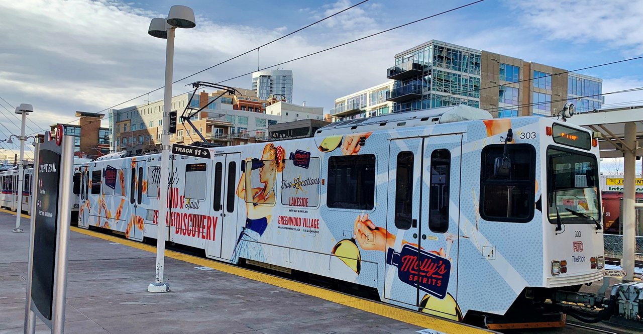 Molly's Spirits rail full wrap advertisement in Lakeside and Greenwood Village, Colorado