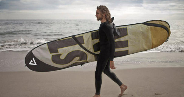 Surfer holding board in a RAREFORM case made out of Lamar Advertising vinyl