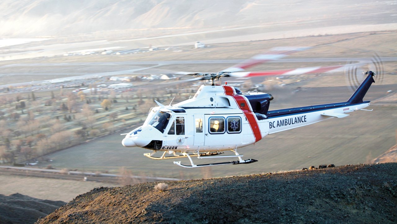 Helicoptor flying over hill