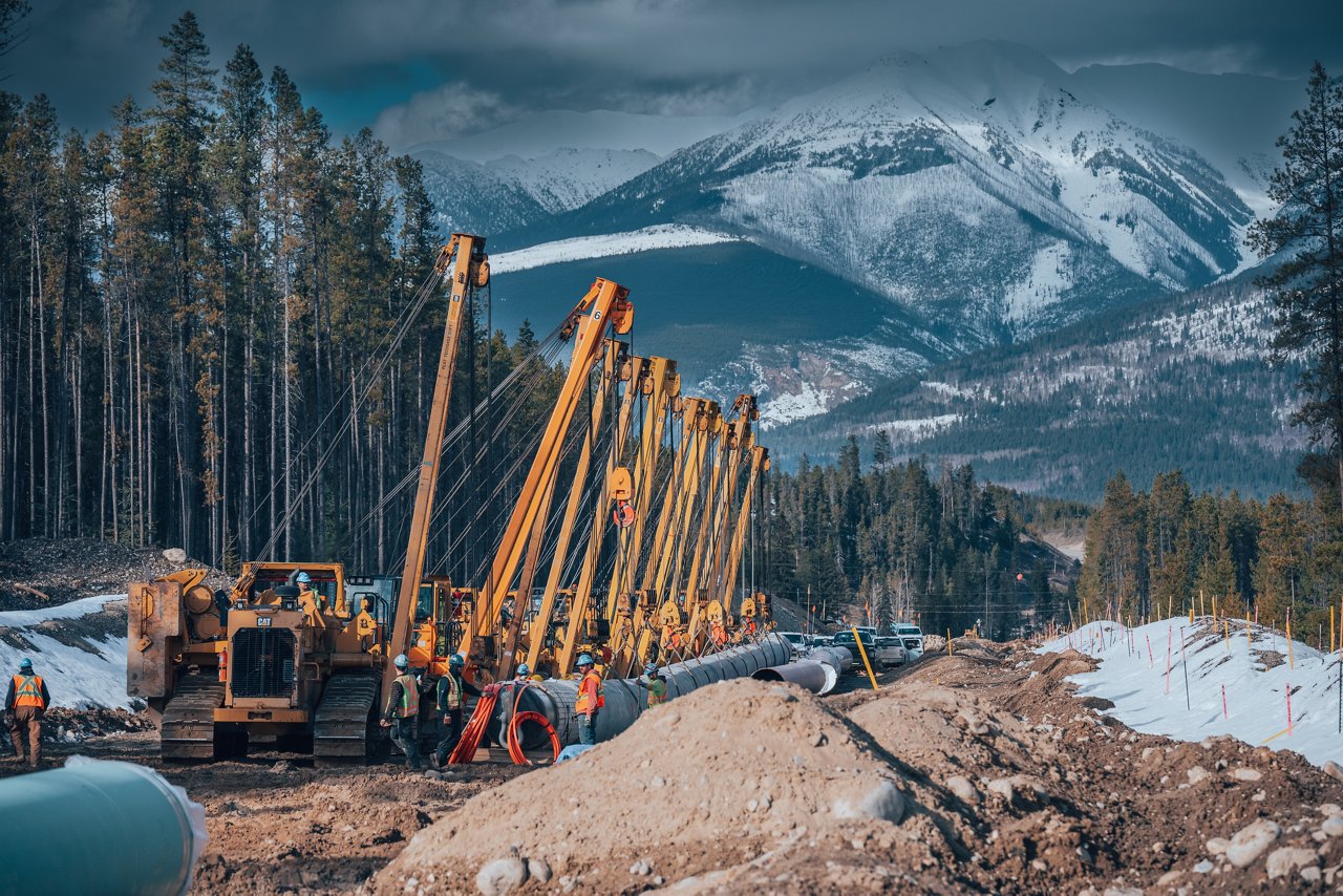 Coastal GasLink Pipeline multiple small cranes laying down pipeline