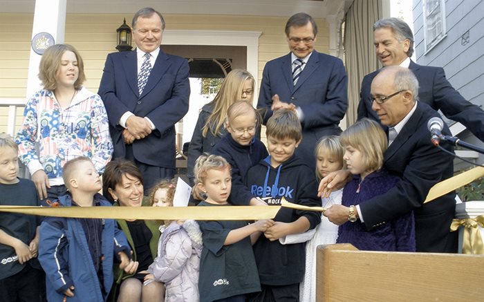 Dave Lede (left), Former Premier Ed Stelmach, Ledcor’s Bob Walker, Mayor Steve Mandel, and Executive Director Val Figliuzzi (sitting) attending the grand opening of Kids with Cancer Society House near the University of Alberta.