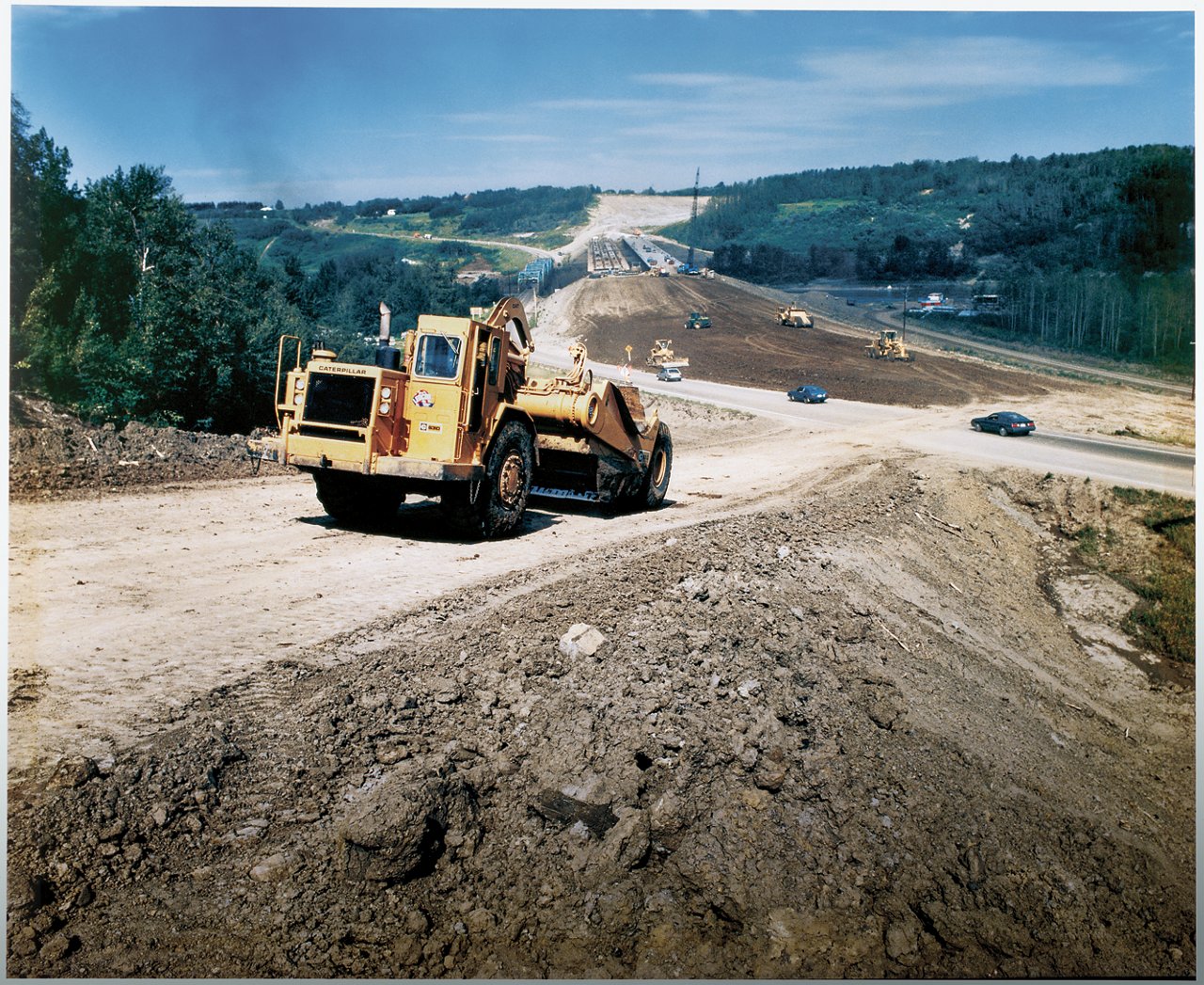 Heavy machine smoothing dirt road