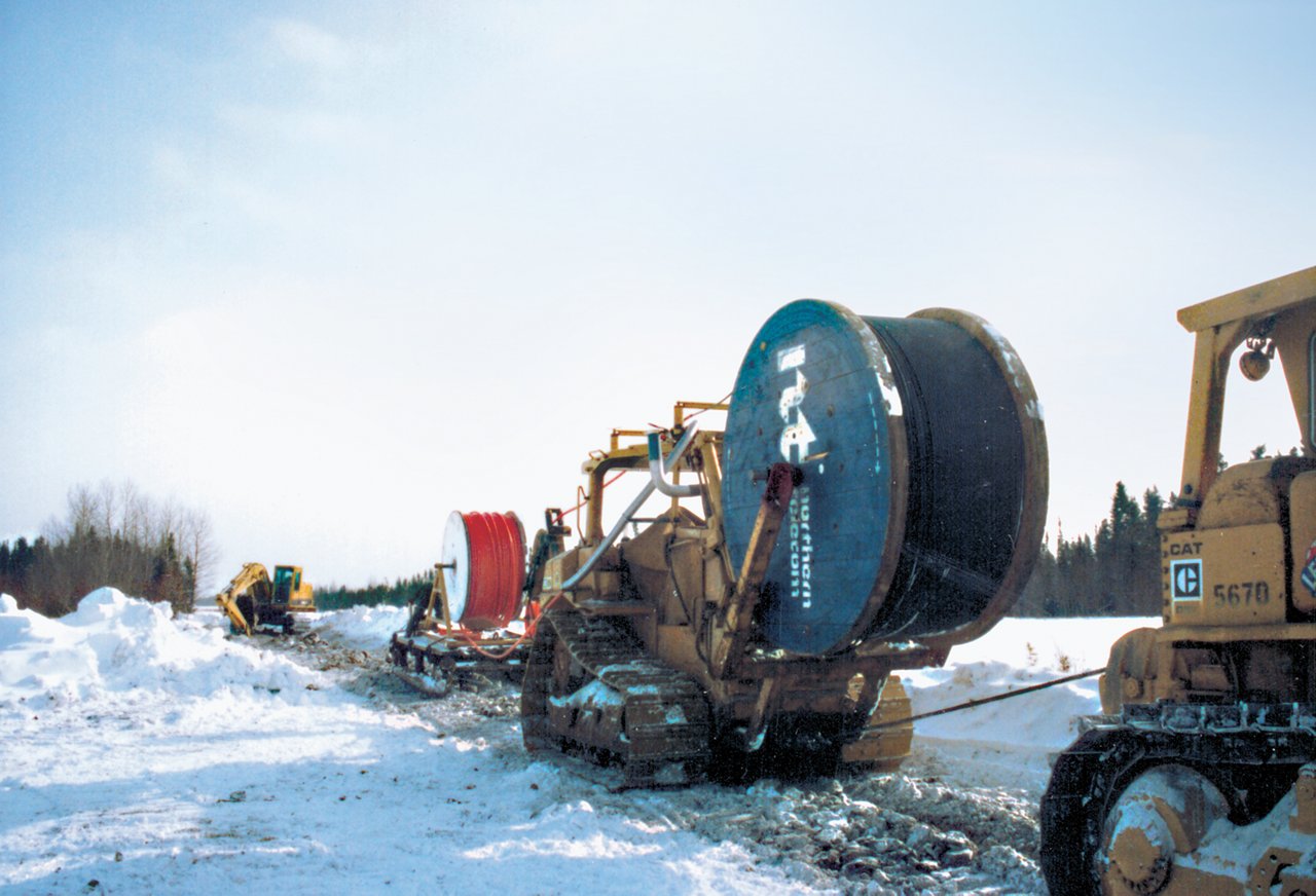 Machines running large wire down snow path