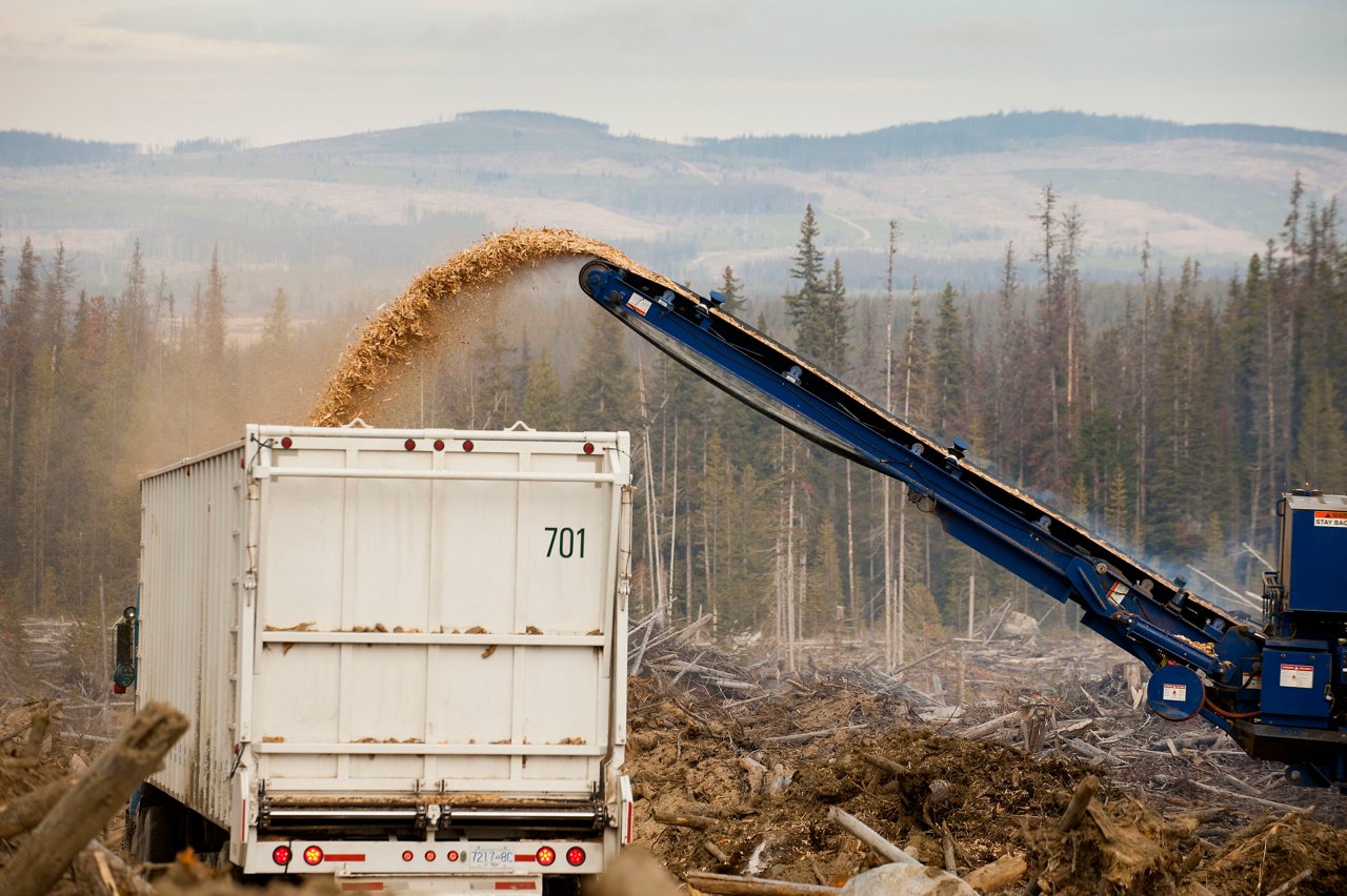 Image of a truck with a machine converting woods into renewable resources.