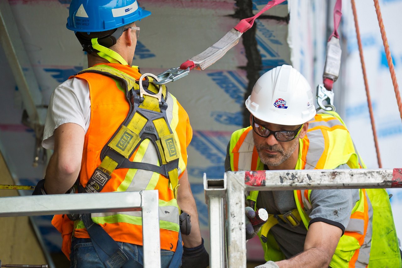 Workers in safety gear and harness