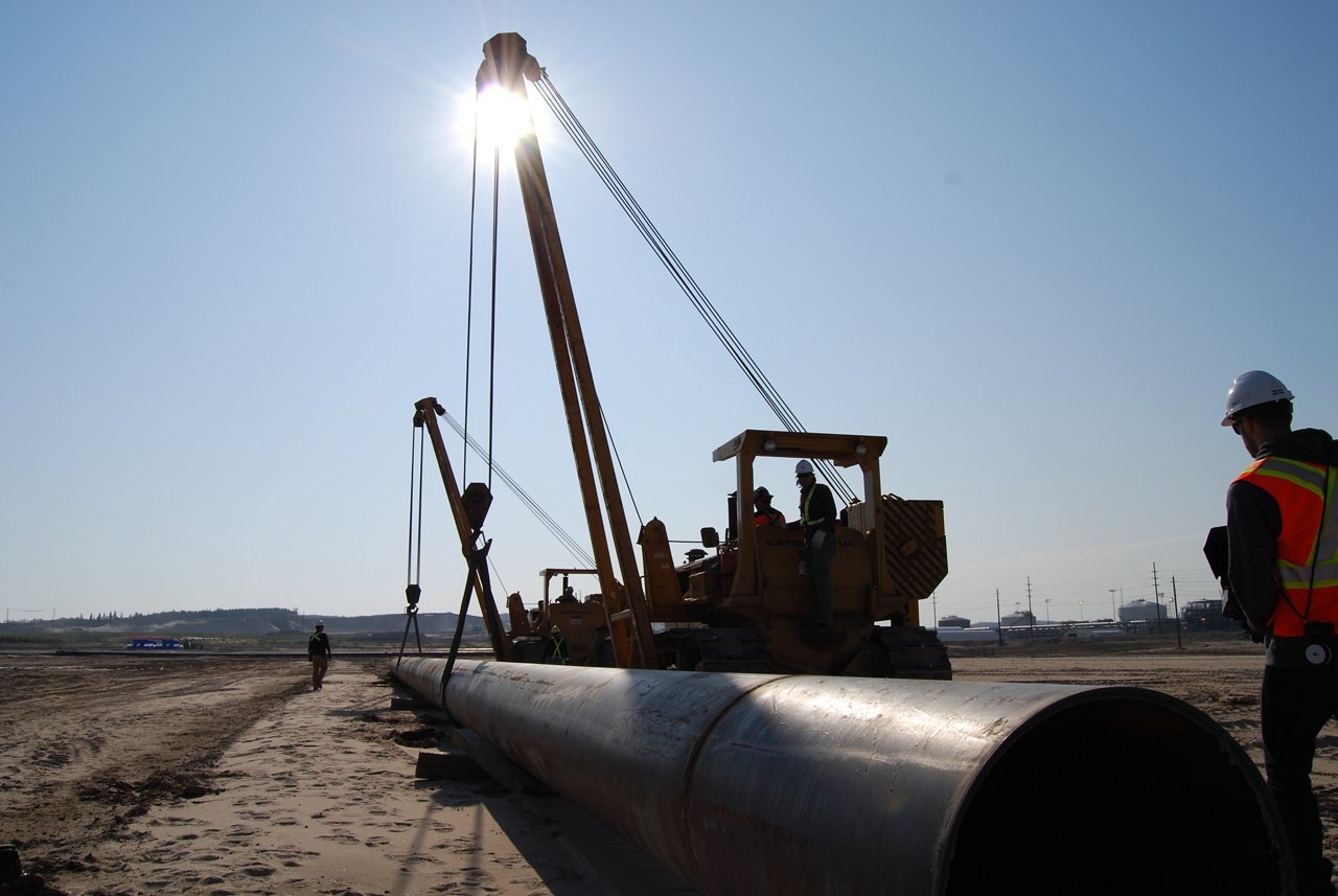 Adjusting the pipes with cranes.