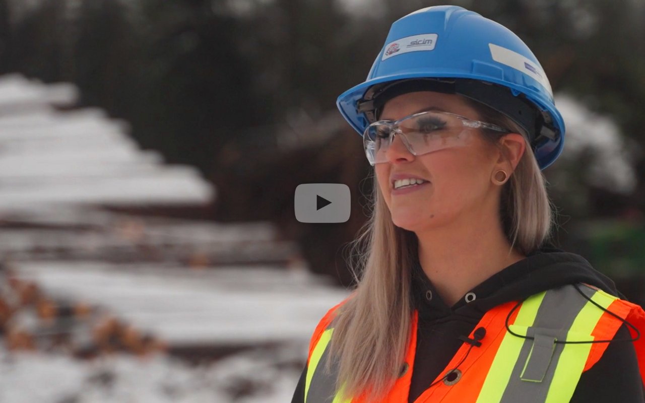 Woman wearing blue safety helmet and orange saftey vest