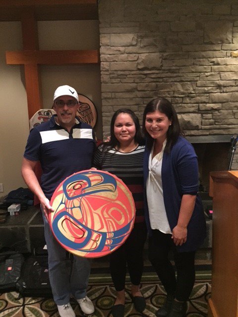 Quentin Huillery, Senior VP of Constructors; Paula Smith, Haisla Nation Job Coach; and Kayla Bordignon, Aboriginal Relations Coordinator are receiving the Eagle/Salmon drum from Haisla Nation.