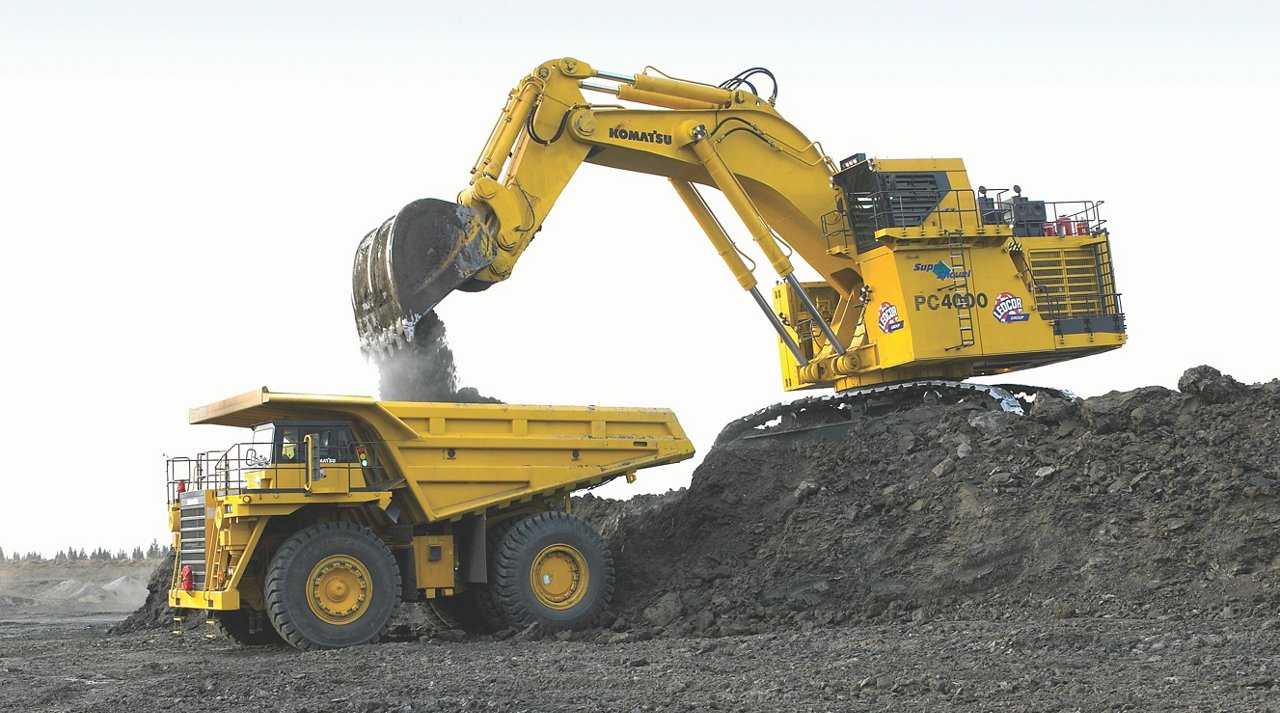 Excavator loading dump truck with dirt