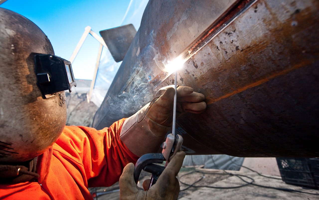 Team Member Welding the pipe.