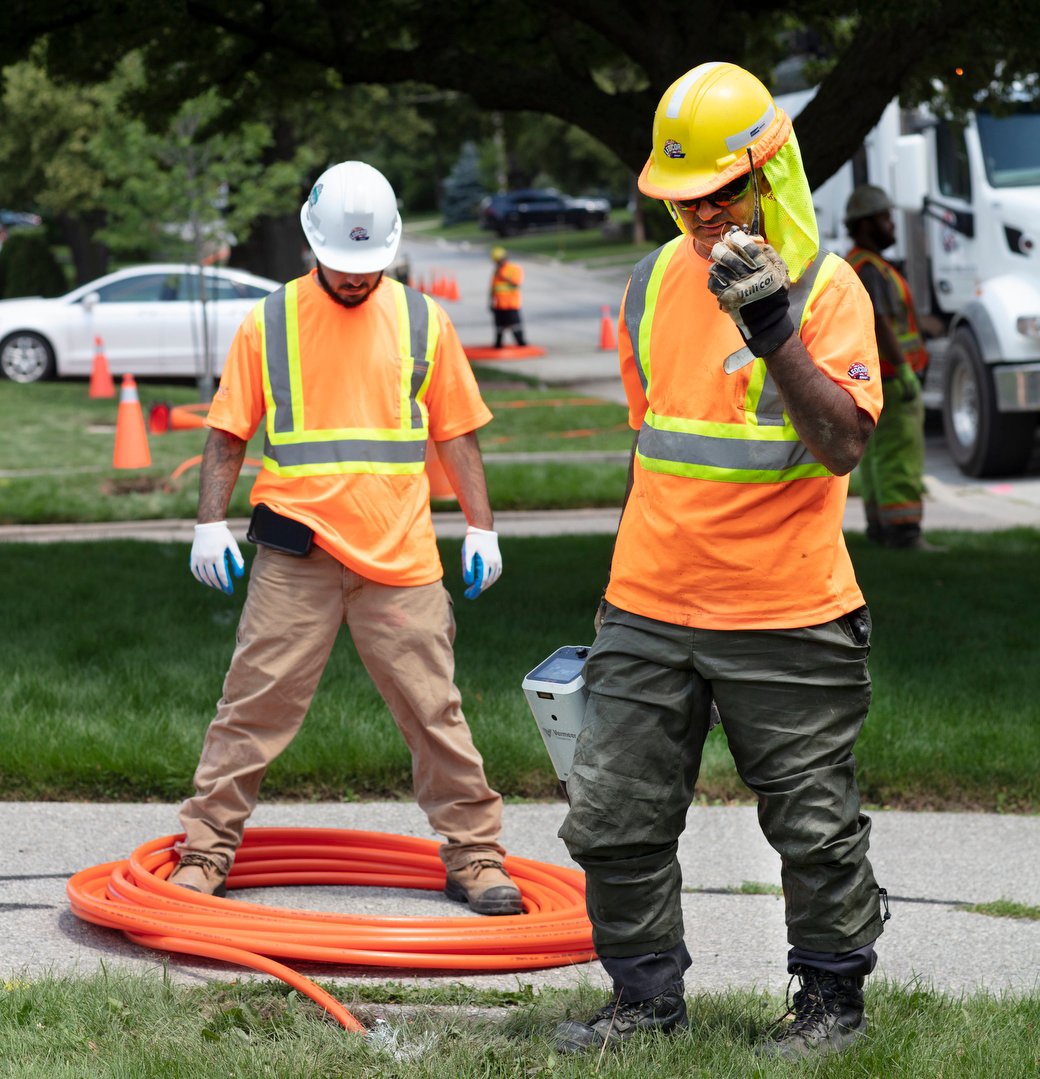 Ledcor workers installing wires.