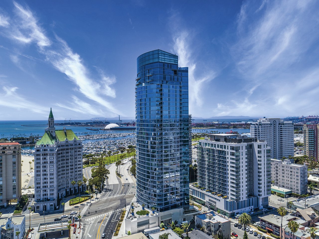 skyshot of large buildings with ocean in the background