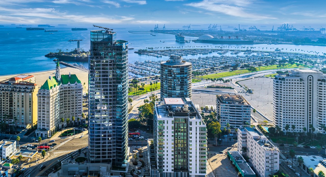 Skyshot of large tower buildings with ocean in the background