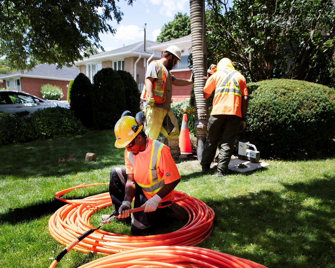 Ledcor worker installing wires.