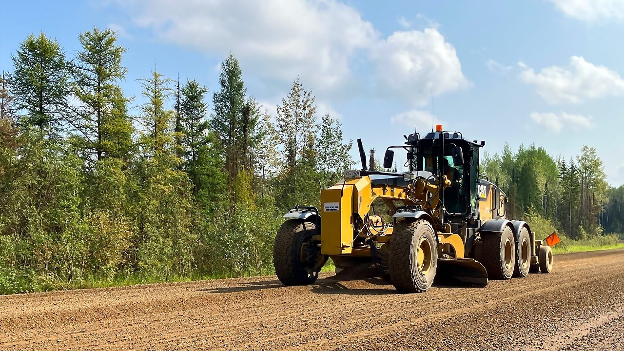 A road construction vehicle maintaining roads in Fort Nelson BC