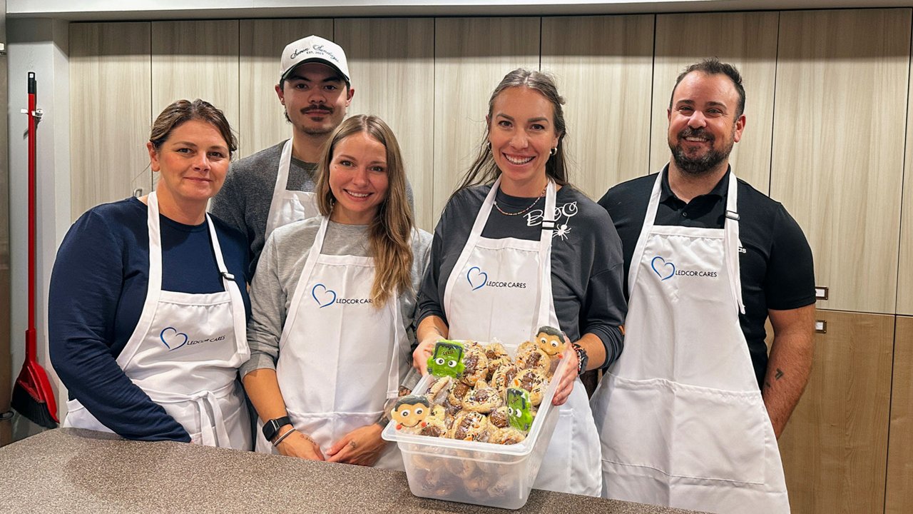 A group of volunteers showing pastries baked at a Ledcor Cares charity event