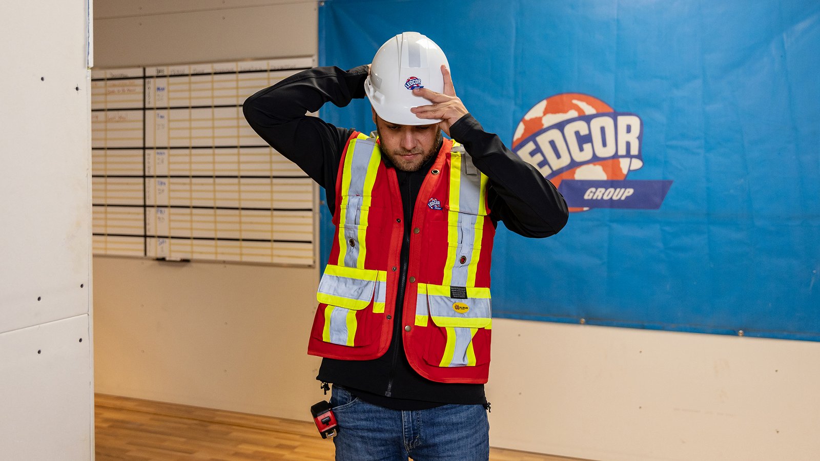 A Ledcor employee putting on a hardhat