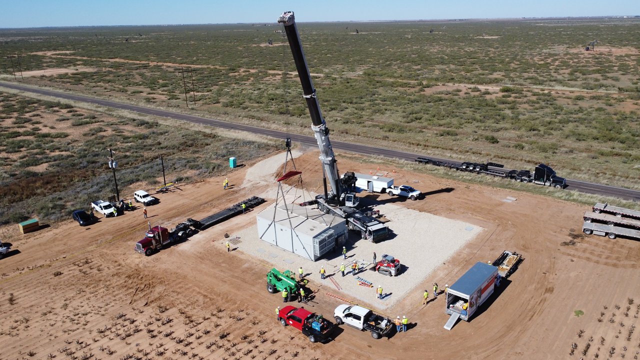 A crane lowering a network communications station