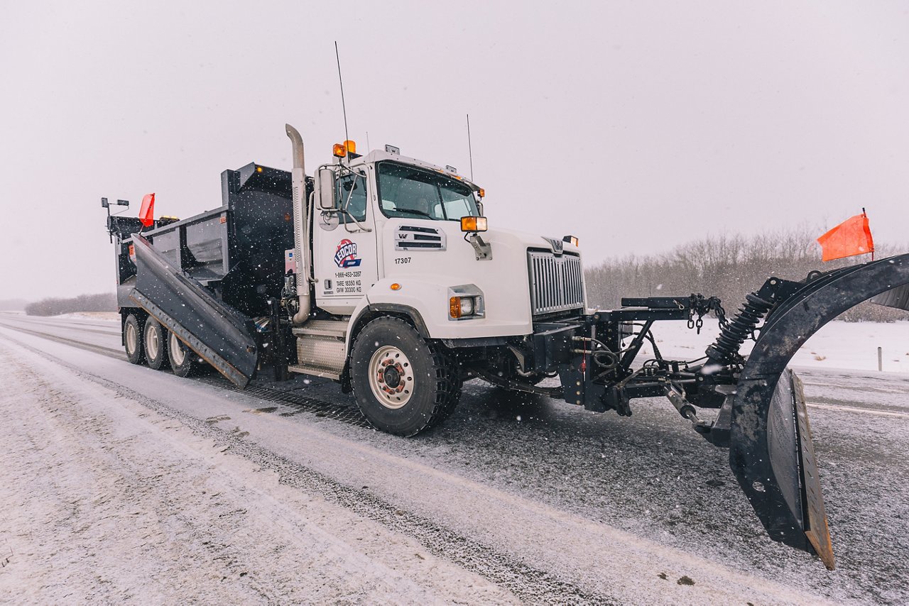 Ledcor Snow Plow Truck maintaing road.