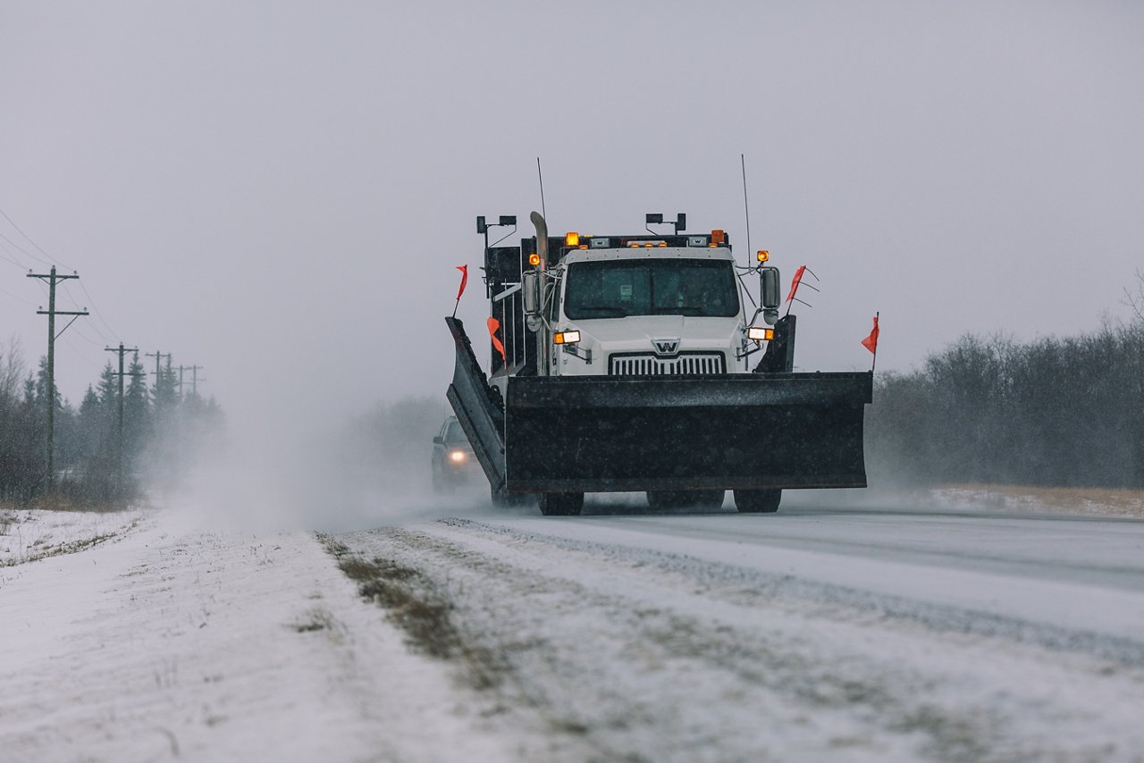 Ledcor Snow Plow Truck maintaing road.