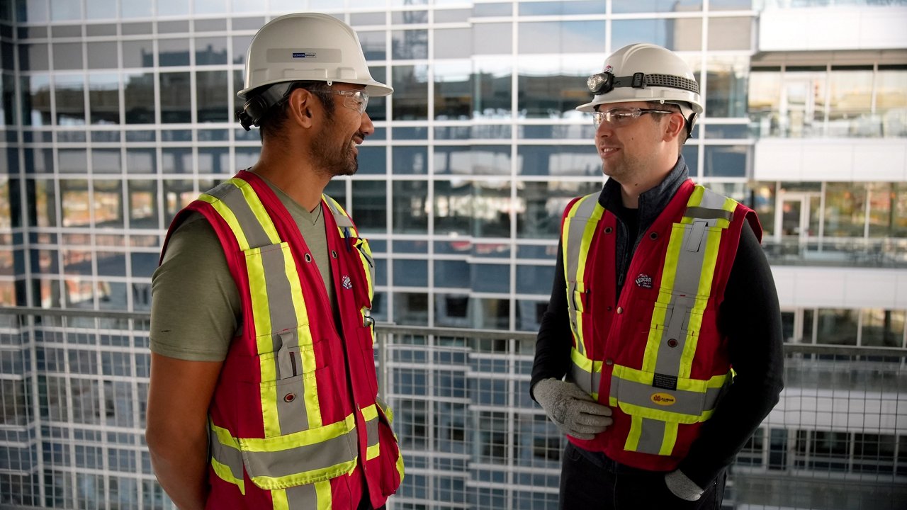 Two construction workers conversing with each other
