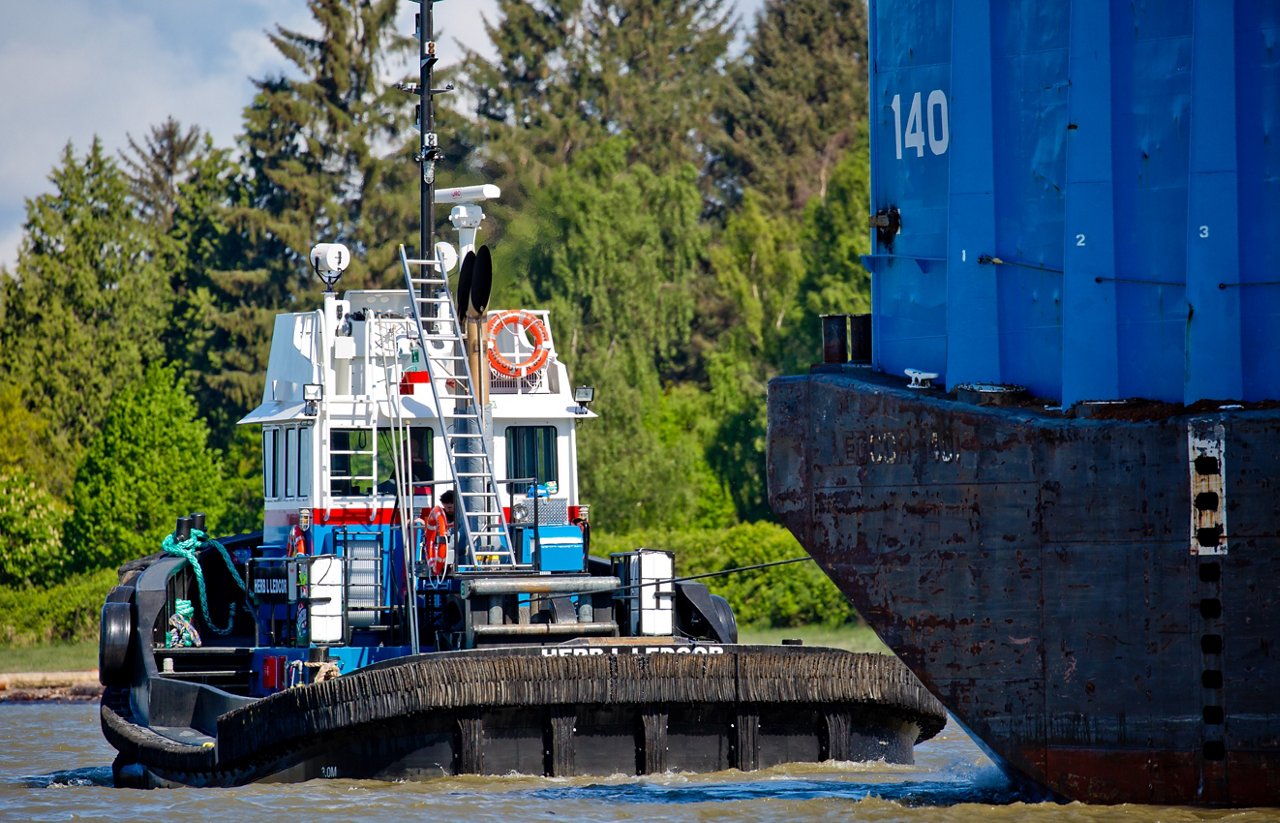 A renewable diesel powered Tugboat towing a barge