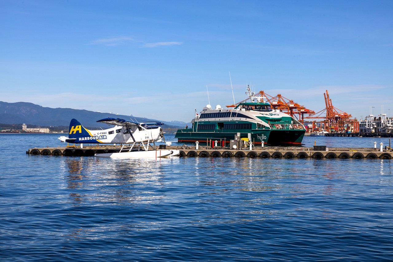 A seaplane and a ferry boat docked at the VHFC