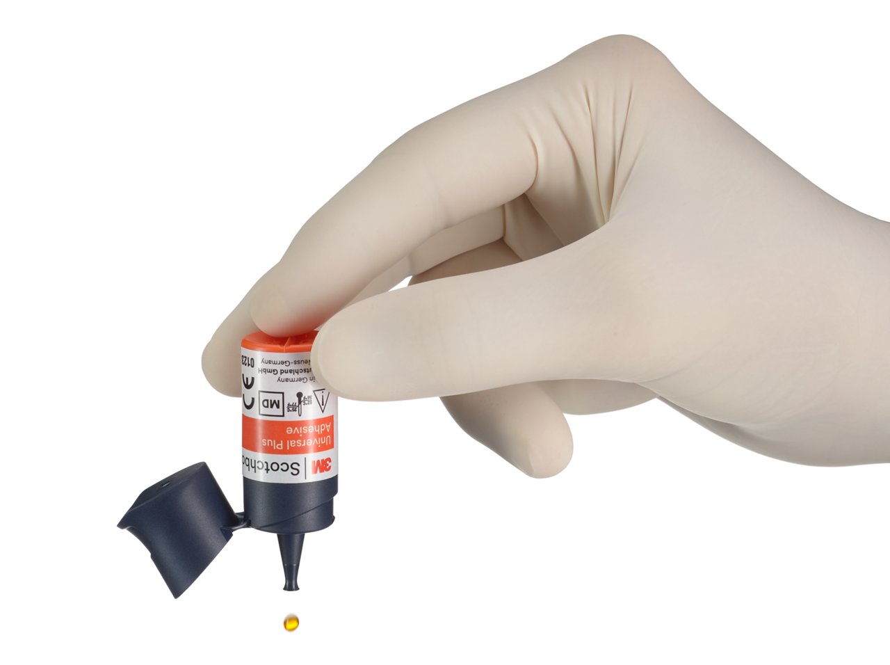 3M Scothbond Universal Plus Adhesive Vial in hand with falling drop