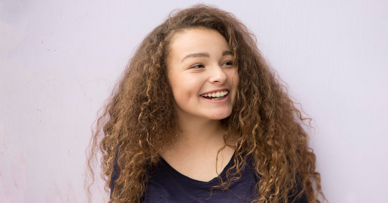 Teen girl smiling indoors