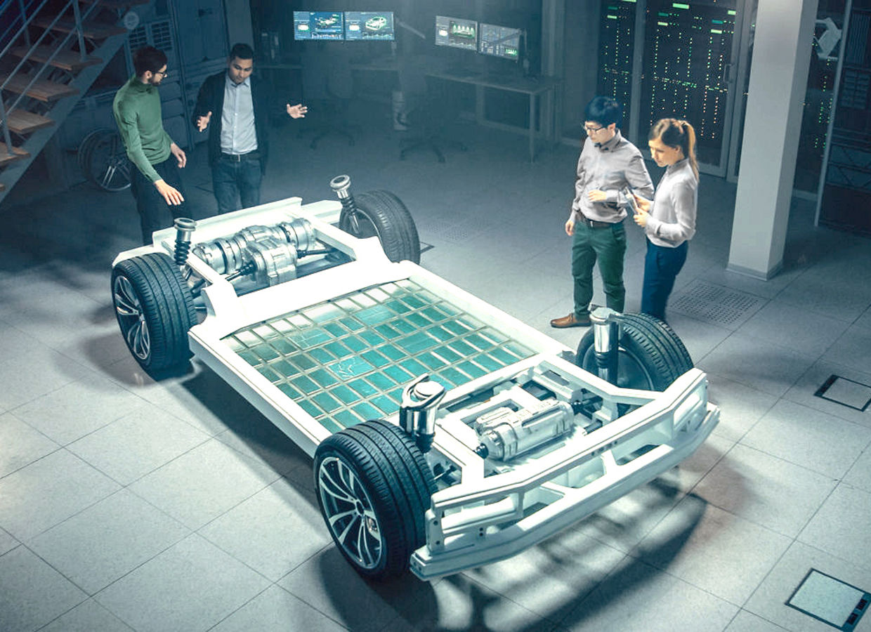 Team of automotive industry engineers working on the chassis platform for electric cars, taking action, working with 3D CAD software, and analyzing efficiency. Vehicle frame with wheels, motor, and battery