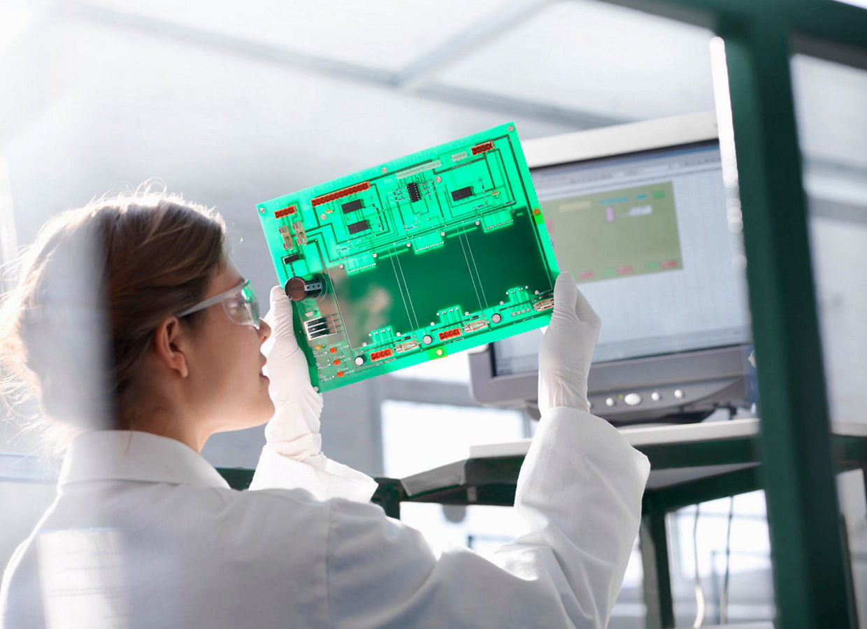 Worker inspects circuit board