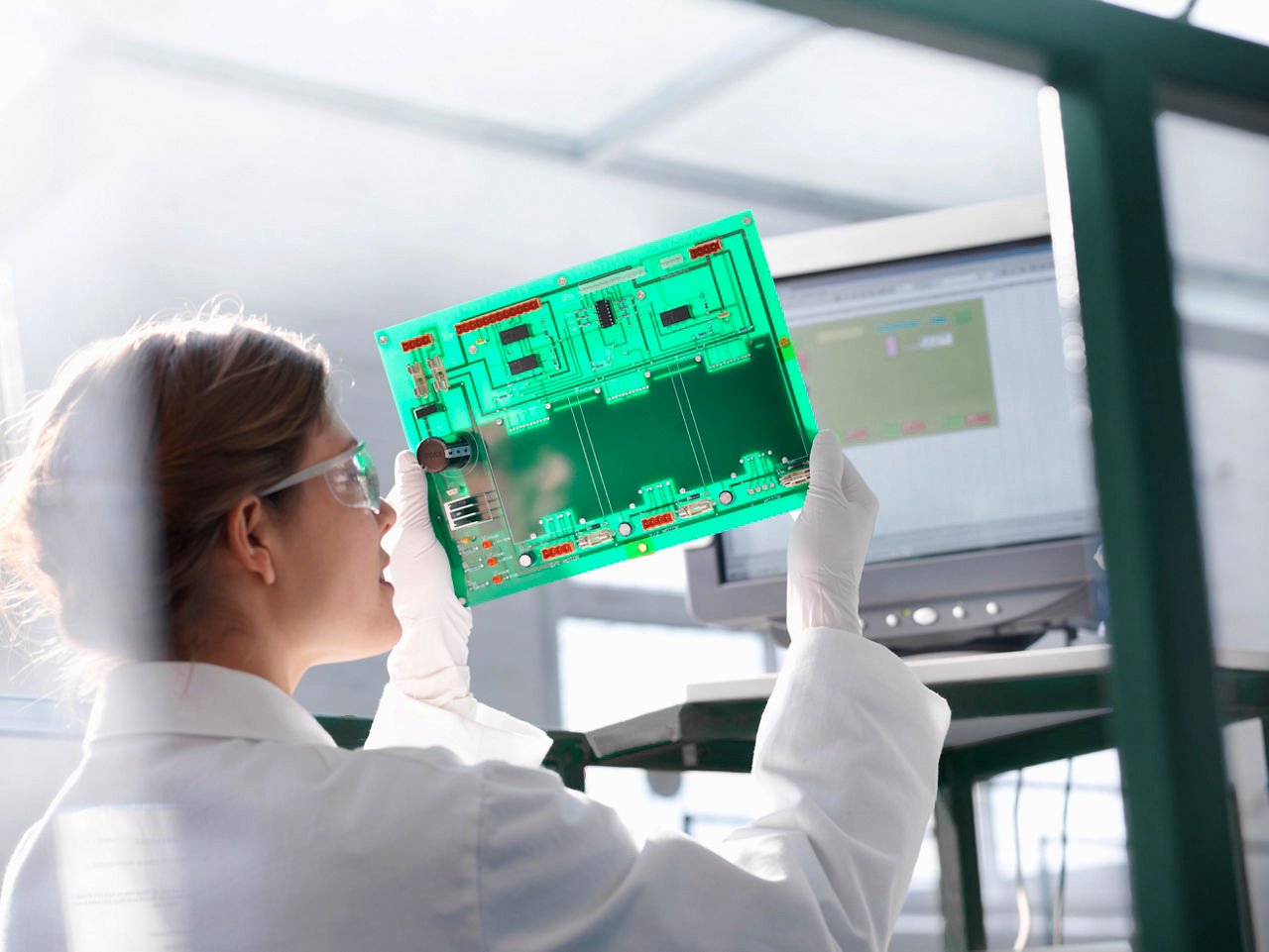 Worker inspects circuit board