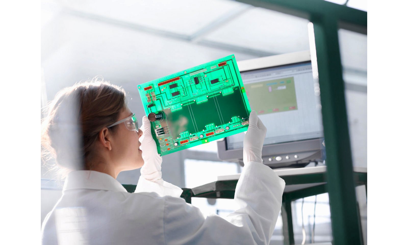 Worker inspects circuit board