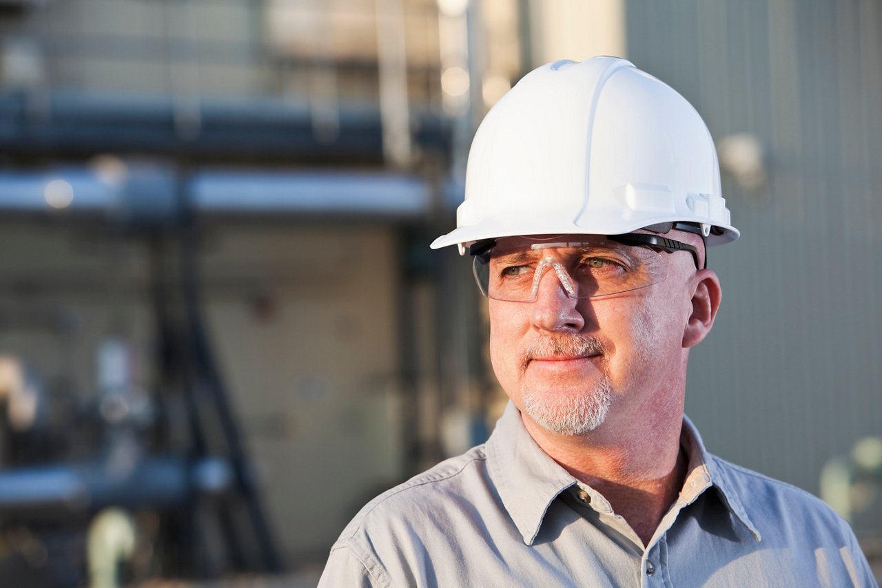 This asset is Getty ID 186809155. This is licensed from Getty Images. Unlimited seats were licensed there is no charge to use this image. Please download and use as needed, but relate this asset to the final assets utilizing this image. Title: Close-up of thoughtful engineer wearing hardhat looking away while standing at construction site.