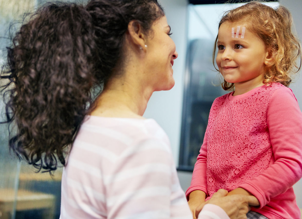 Wound clinic - Mother and daughter smiling after the Steri-Strip™ application to daughter's forehead wound, A1841
