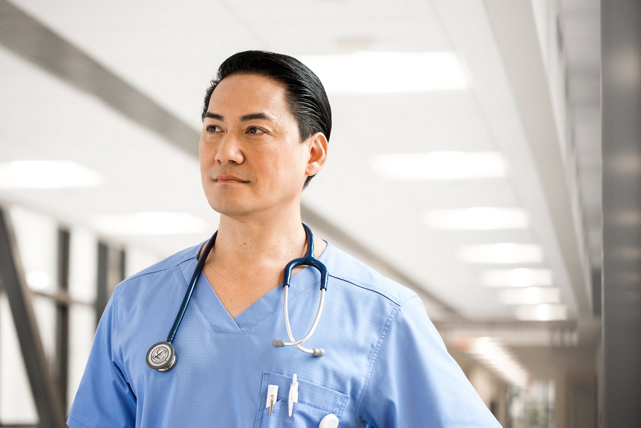 Male nurse portrait in hospital corridor