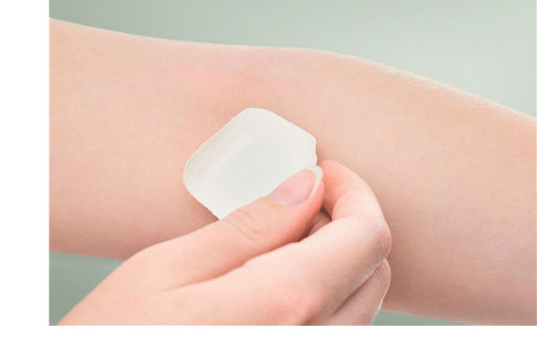 The girl sticks a patch on the elbow after giving blood from a vein. Concept for hospitals, laboratories, donation support