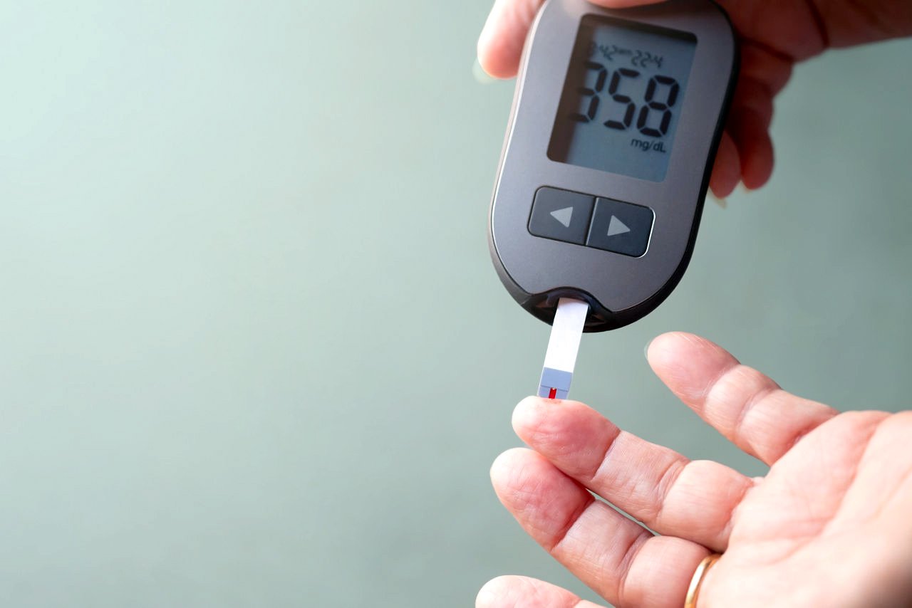 Old women checks the amount of sugar in the blood.  High blood sugar lever