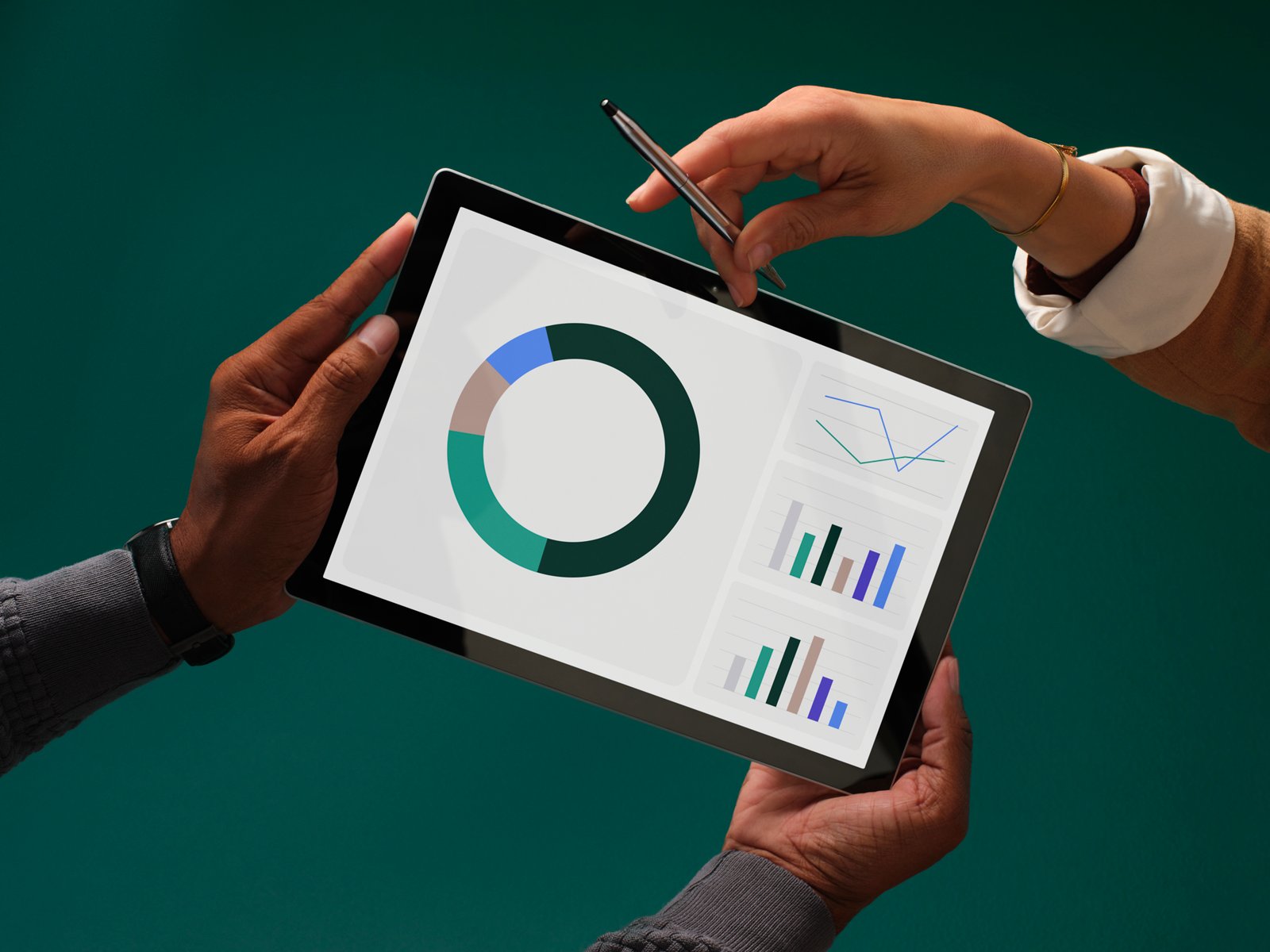 Male hands hold a tablet with colorful graphs and charts on the screen, while a woman's hand holding a stylus pen reaches over to point at the screen, all on a dark green background.