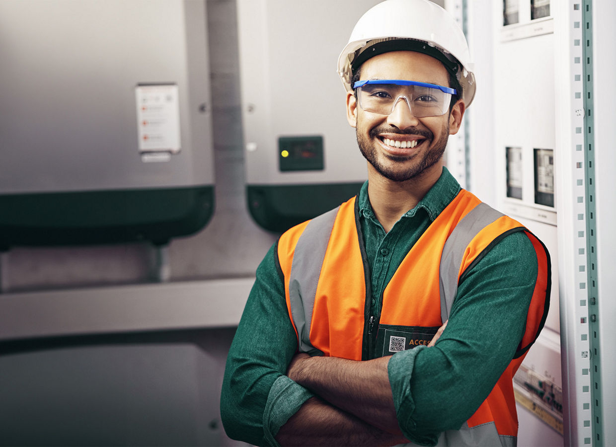 Portrait of a man in a hard hat, safety glasses and a safety vest