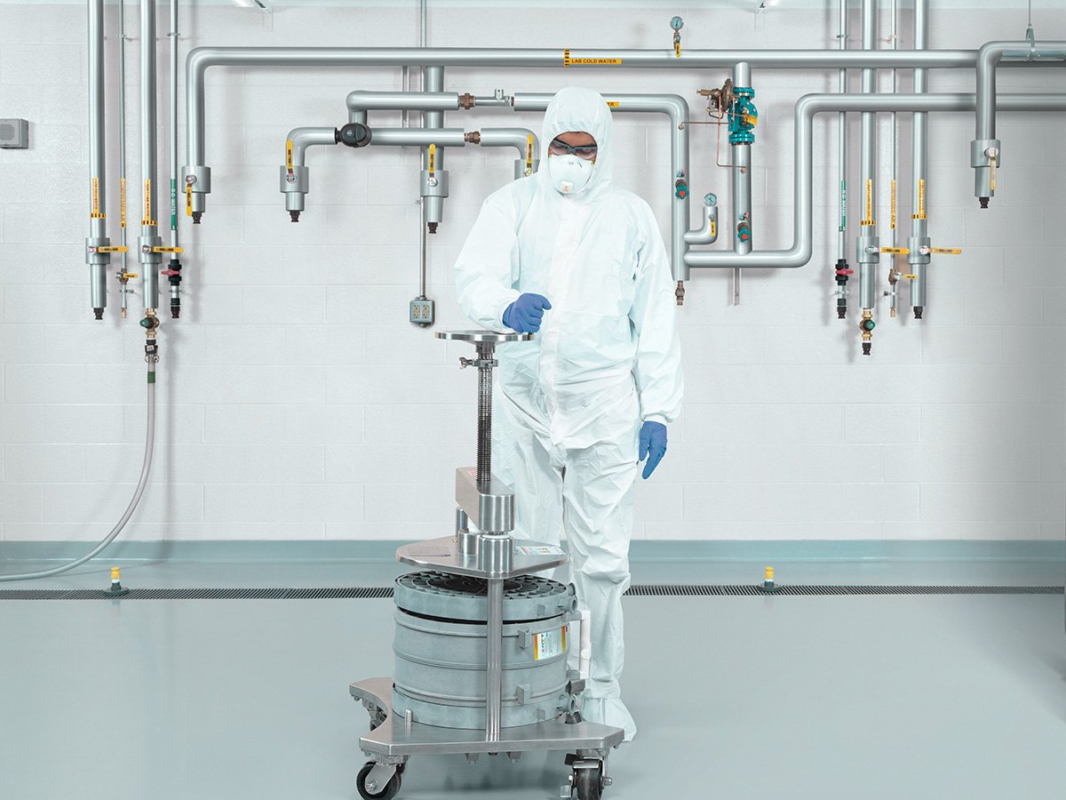 Bioprocessing technician setting up a pilot scale product holder and capsules