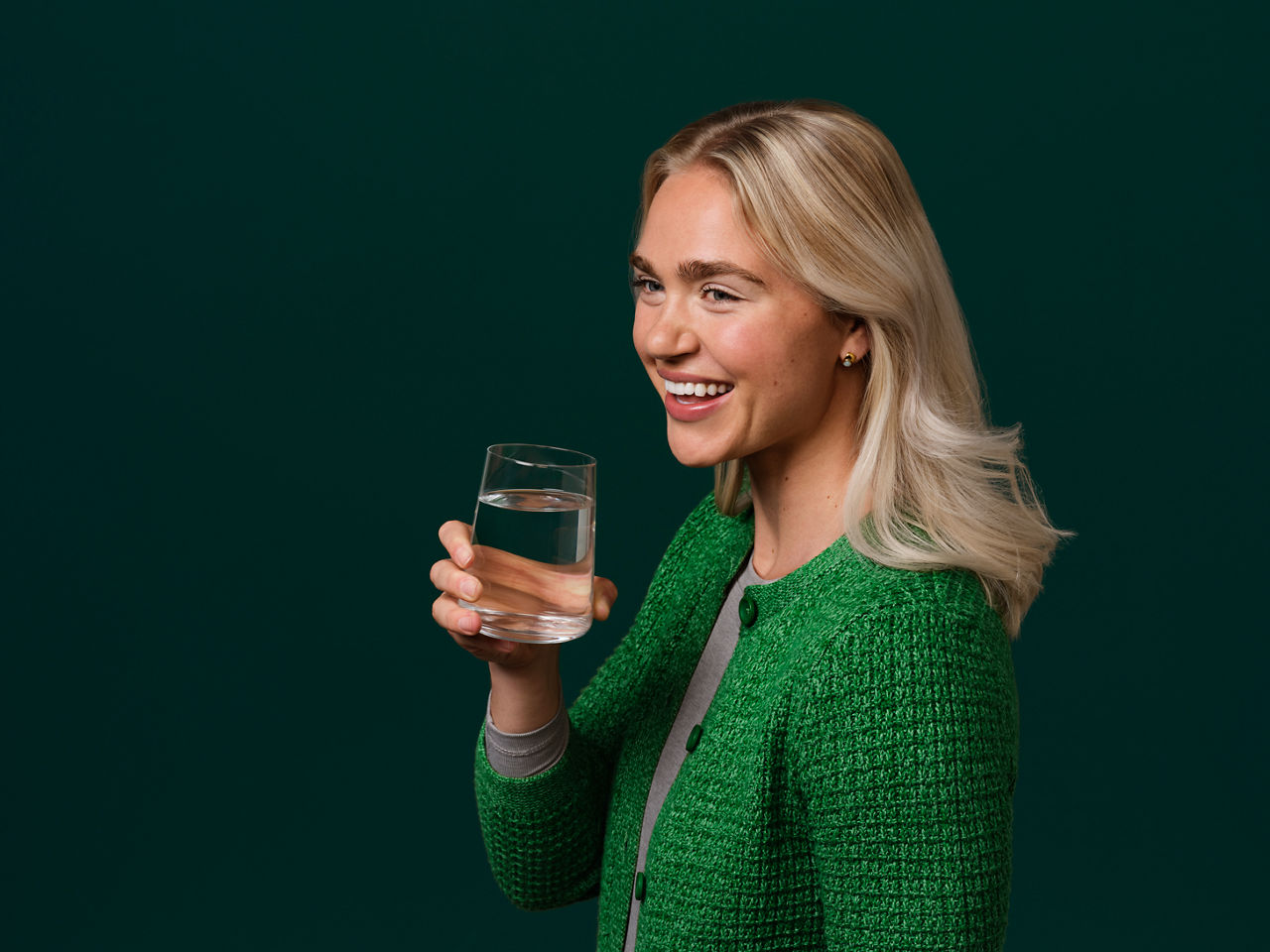 Image of a woman drinking water from a glass.