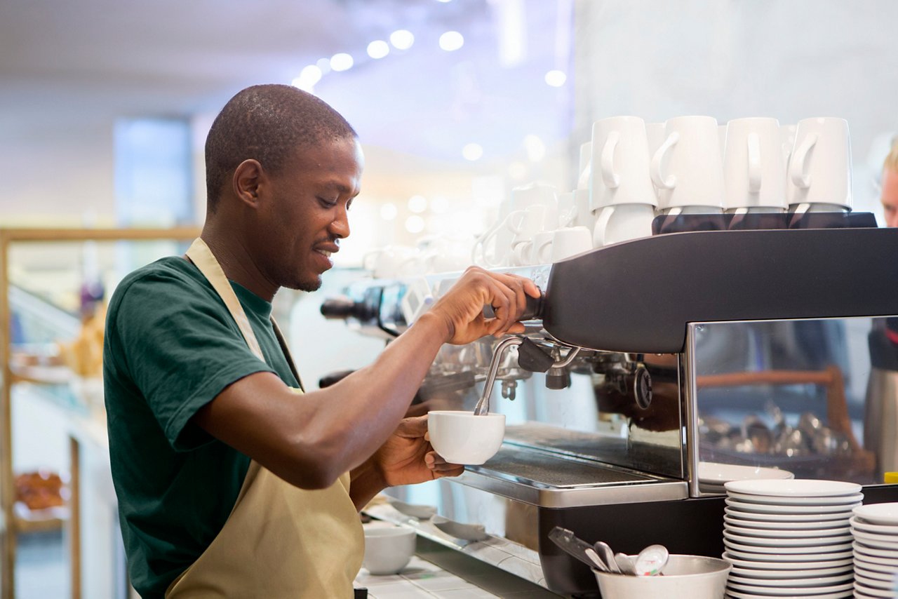 African american male barista making espresso