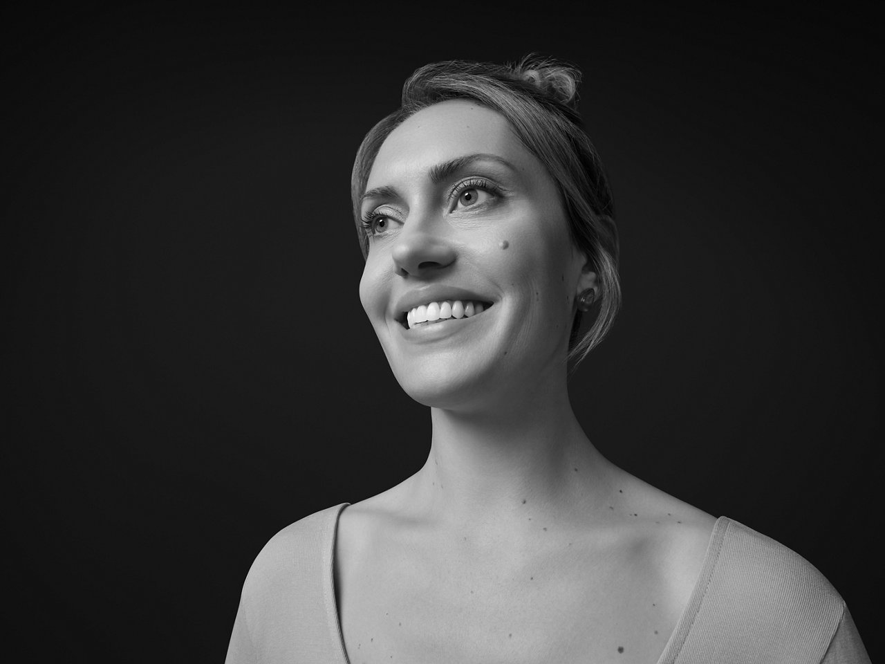 A woman gives a healthy smile.