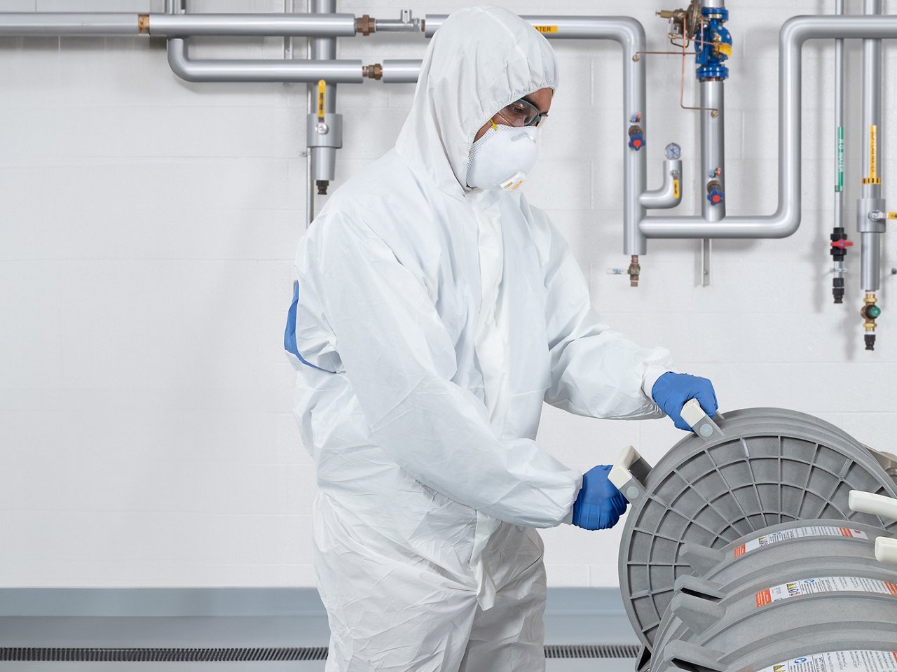 Bioprocessing technician loading capsules into holder