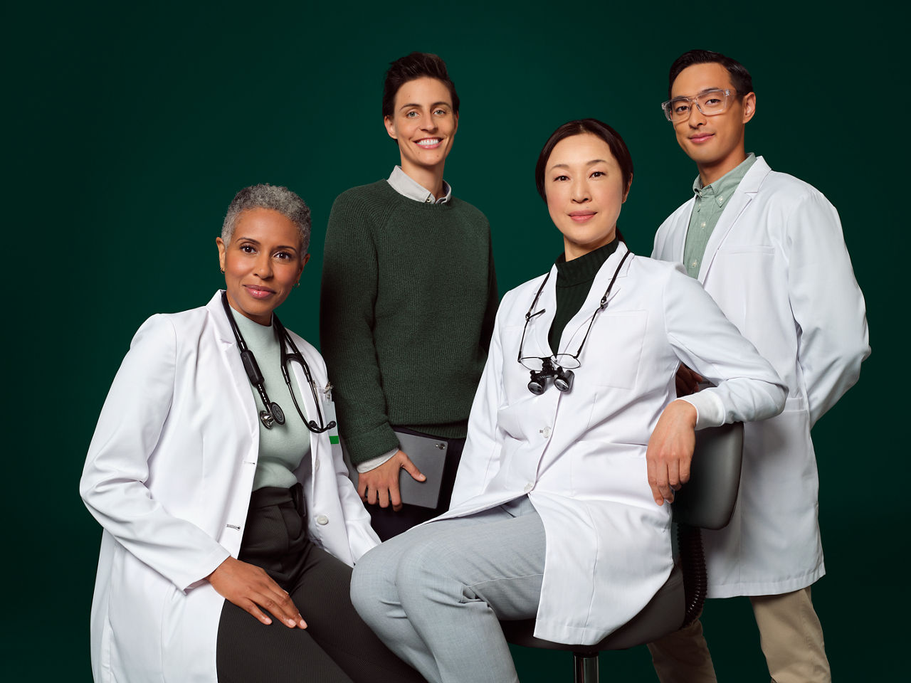 En läkare med stetoskop, en tandläkare med luppar, ingenjör/vattenexpert och person som kodar programvara.