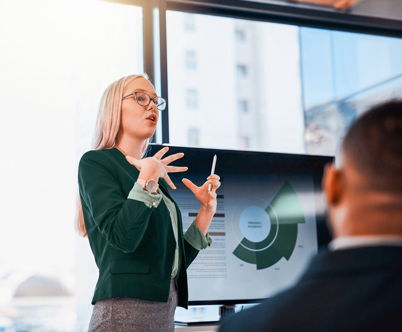 Young woman presenting data during a meeting.