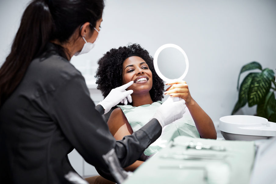 A female assistant talking with a female orthodontic patient