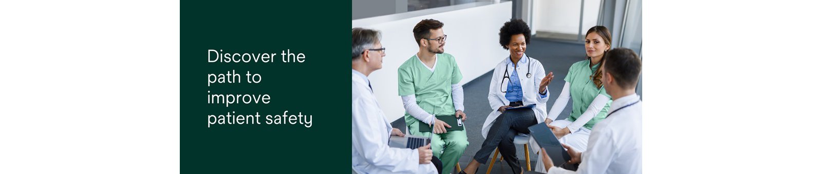 A group of healthcare professionals including doctors, nurses and specialists seated in a circle who are interacting. A couple of them are smiling.