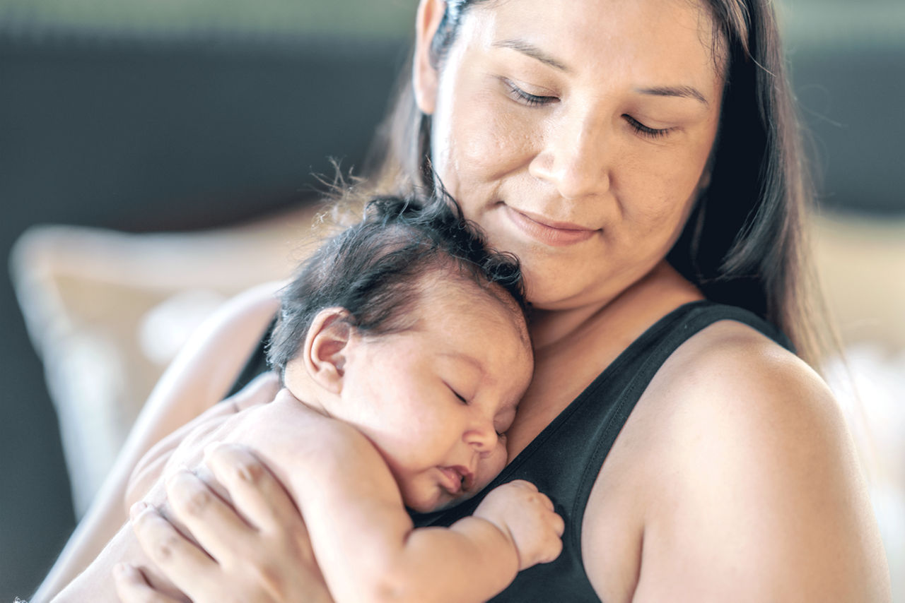 A mother holding her baby.